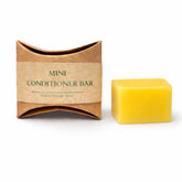 Yellow mini conditioner bar with brown packaging on a white background
