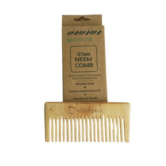 Wooden comb with Shunya packaging on a gray background